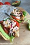 Grilled Chicken Avocado Naan Wraps - Ready in no time and loaded to the max with ingredients as well as flavor! Cilantro lime chicken, avocado, Sriracha Yogurt Sauce, lettuce, tomatoes, and cucumber! Great meal for any day of the week! www.withpeanutbutterontop.com