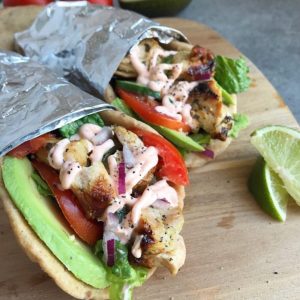 Grilled Chicken Avocado Naan Wraps - Ready in no time and loaded to the max with ingredients as well as flavor! Cilantro lime chicken, avocado, Sriracha Yogurt Sauce, lettuce, tomatoes, and cucumber! Great meal for any day of the week! www.withpeanutbutterontop.com