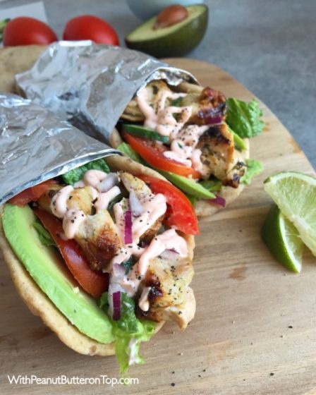 Grilled Chicken Avocado Naan Wraps - Ready in no time and loaded to the max with ingredients as well as flavor! Cilantro lime chicken, avocado, Sriracha Yogurt Sauce, lettuce, tomatoes, and cucumber! Great meal for any day of the week! www.withpeanutbutterontop.com