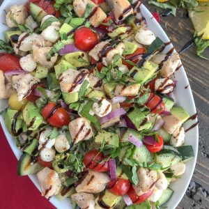 This Chicken Avocado and Cucumber Caprese Salad will become your next healthy habit. Not just for how quick and fool-proof it is to put together, but for the delicious flavor combination. The great thing about this recipe? It can easily be a no-cook recipe! #caprese #salad #capresesalad #wraps #avocado #healthy | https://withpeanutbutterontop.com