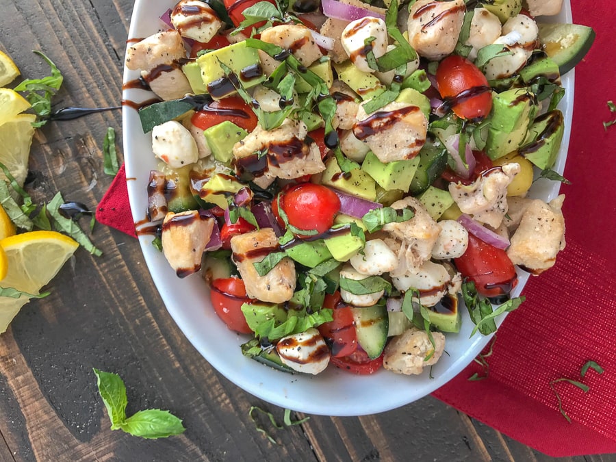 This Chicken Avocado and Cucumber Caprese Salad will become your next healthy habit. Not just for how quick and fool-proof it is to put together, but for the delicious flavor combination. The great thing about this recipe? It can easily be a no-cook recipe! #caprese #salad #capresesalad #wraps #avocado #healthy | https://withpeanutbutterontop.com