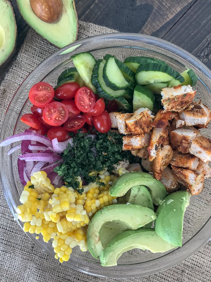 Cajun LimeÂ Chicken Avocado Corn SaladÂ  - this salad has so much flavor! Creamy, light, and drizzled with a Cilantro Lime Dressing. It is quick and easy to make and perfect for your next barbecue or get together. Light on the calories, coming in at only 203 calories per 1 cup serving. The best part? It's just as delicious the next day, making this a good meal for your to-go lunches. #avocado #salad #chickensalad #healthy | https://withpeanutbutterontop.com