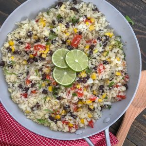 Cilantro Lime Black Bean and Corn Cauliflower Rice - an incredibly easy and flavorful side dish that is packed full of veggies and can be on your plate in 15 minutes or less! 115 calories per serving! #healthy #cauliflowerrice #glutenfree #vegan #healthy | https://withpeanutbutterontop.com