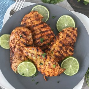 Grilled Cajun Lime Chicken - juicy, tender and flavorful chicken that is super easy to make and can be on your table in under 15 minutes! And can you really go wrong with a delicious slice of chicken that is under 200 calories?? #healthy #cajunseasoning #cajun #chickenbreast #grilledchicken #dinner | https://withpeanutbutterontop.com