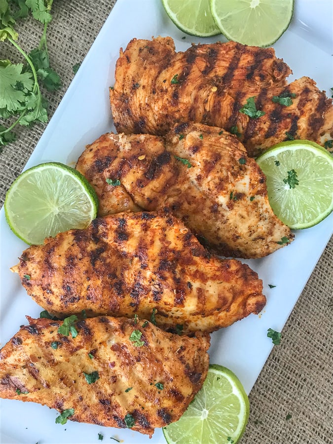 Grilled Cajun Lime Chicken - juicy, tender and flavorful chicken that is super easy to make and can be on your table in under 15 minutes! And can you really go wrong with a delicious slice of chicken that is under 200 calories?? #healthy #cajunseasoning #cajun #chickenbreast #grilledchicken #dinner | https://withpeanutbutterontop.com