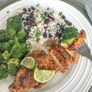 Easy Grilled Jamaican Jerk Chicken - this marinated jerk chicken is truly the most delicious summertime grilling recipe! It's a zesty-lime and spice flavor bomb from the very first bite! Easy to make, full of flavor, and perfect for meal prepping. #chicken #healthy #grilled | https://withpeanutbutterontop.com