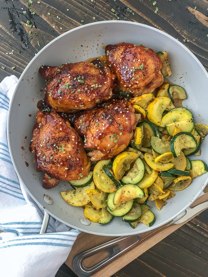 This One-Pan Honey Garlic Chicken Thighs and Squash recipe is the bee's knees! The chicken thighs are cooked in an incredibly delicious honey garlic sauce glaze and is easy to make. Bonus: this entire recipe is cooked using only one pan, making cleanup a breeze! #chickenthighs #honeygarlic #onepan #dinner #chicken | https://withpeanutbutterontop.com