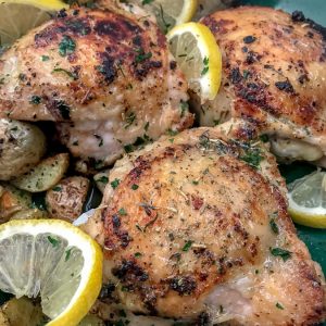 One Pan Lemon Garlic Butter Chicken and Potatoes - this dish is not only incredibly easy to make, but it is also bursting with zingy lemon garlic flavor! Chicken that is crispy on the outside, yet tender and juicy on the inside. Cooked in one pan, making for easy cooking and clean up. #onepanmeals #onepan #chicken | https://withpeanutbutterontop.com