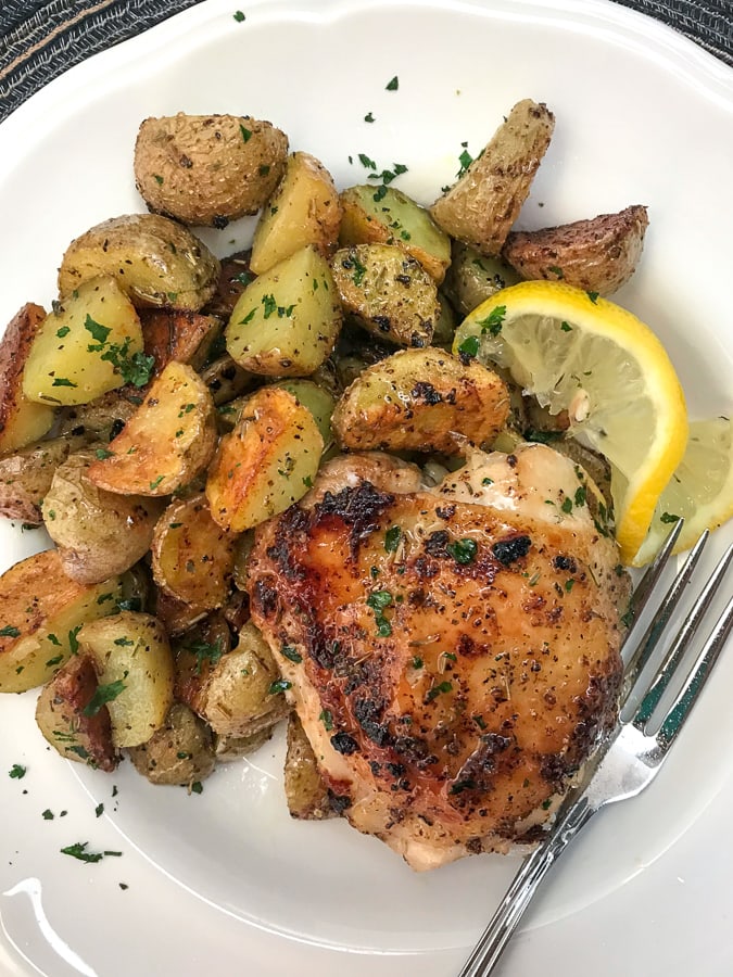 One Pan Lemon Garlic Butter Chicken and Potatoes - this dish is not only incredibly easy to make, but it is also bursting with zingy lemon garlic flavor! Chicken that is crispy on the outside, yet tender and juicy on the inside. Cooked in one pan, making for easy cooking and clean up. #onepanmeals #onepan #chicken | https://withpeanutbutterontop.com