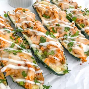 Buffalo Chicken Stuffed Zucchini Boats - a super simple and delicious 5-ingredient recipe that your family will love! #zucchini #buffalochicken #recipes |https://withpeanutbutterontop.com