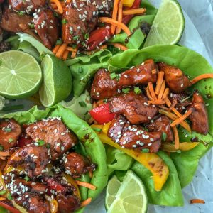 Honey Garlic Chicken Lettuce Wraps - low carb, sweet and savory, and full of flavor. #honeygarlicchicken #lowcarb #healthy #lettucewrap | https://withpeanutbutterontop.com