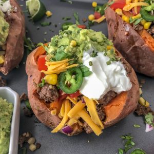 Taco Stuffed Sweet Potatoes - a simple and easy healthy spin on #TacoTuesday that you and your family are going to absolutely love! Full of flavor and perfect for those taco cravings! #taco #tacos #healthy #stuffedsweetpotatoes #tacostuffed | https://withpeanutbutterontop.com