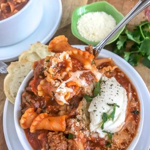 Easy One Pot Lasagna Soup - a delightful twist on a comforting dish. Guaranteed to become a family favorite as it tastes just like lasagna, but requires no layering or baking. Just ONE pot! Bursting with flavor, full of noodles and cheese, and Italian spices. #lasagna #lasagnasoup #soup #onepot #onepotmeals | https://withpeanutbutterontop.com