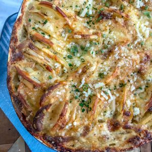 Cheesy Hasselback Potatoes - perfect for those who love crispy, cheesy potatoes! Golden and crispy potatoes that are easy to make, full of flavor, and a wonderful side dish to any meal. #potatoes #sidedish #baked #cheesyhasselback | https://withpeanutbutterontop.com