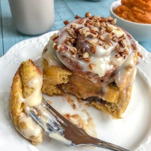 Pumpkin Cinnamon Rolls with Cream Cheese Frosting - a perfect, fall twist to a classic breakfast favorite! Fill your home and your tummies with this amazing, flavor-packed dessert! #pumpkin #cinnamonrolls #pumpkincinnamonrolls #breakfast #fall | https://withpeanutbutterontop.com