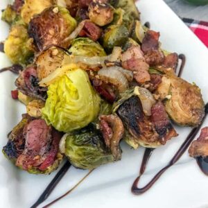 Roasted Balsamic Brussels Sprouts - an easy, fantastic side dish that is full of flavor - crispy, roasted brussels sprouts, savory and salty bacon, and a delicious tangy balsamic glaze! #brusselssprouts #sidedish #thanksgiving | https://withpeanutbutterontop.com