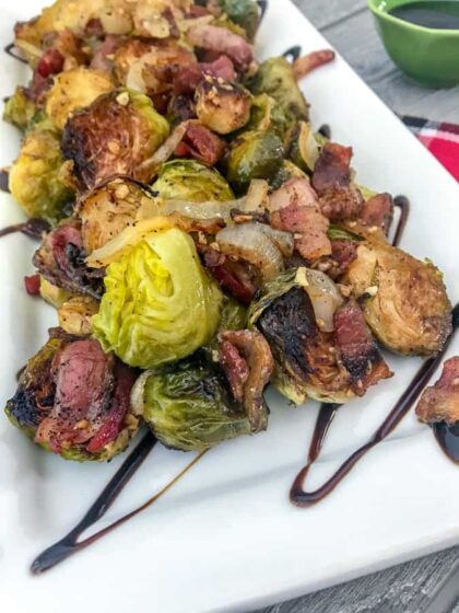 Roasted Balsamic Brussels Sprouts - an easy, fantastic side dish that is full of flavor - crispy, roasted brussels sprouts, savory and salty bacon, and a delicious tangy balsamic glaze! #brusselssprouts #sidedish #thanksgiving | https://withpeanutbutterontop.com