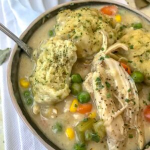Easy One Pot Chicken and Herb Dumplings - the ultimate comfort dish, but lightened up!! Full of flavor, vegetables, and tender, juicy chicken topped with fluffy butter-herb dumplings! A keeper!! #soup #onepotmeals #chickenanddumplings | https://withpeanutbutterontop.com