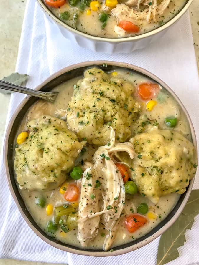 Easy One Pot Chicken and Herb Dumplings - the ultimate comfort dish, but lightened up!! Full of flavor, vegetables, and tender, juicy chicken topped with fluffy butter-herb dumplings! A keeper!! #soup #onepotmeals #chickenanddumplings | https://withpeanutbutterontop.com