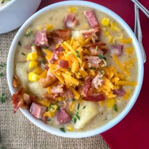 Instant Pot Ham Potato and Corn Chowder - an easy-to-make, one pot soup that uses leftover ham bone and ham from the holidays! Full of sweet corn, potatoes, and salty chunks of ham. Sure to be a crowd pleaser at your dinner table! #soup #hambone #ham #chowder #onepot | https://withpeanutbutterontop.com