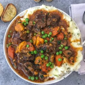 Instant Pot Sweet Potato Beef Stew - Learn how to make the BEST beef stew in the Instant Pot in approximately 1 hour! Full of flavor, vegetables, sweet potatoes and the most tender beef! #beefstew #instantpot #instantpotbeefstew | https://withpeanutbutterontop.com