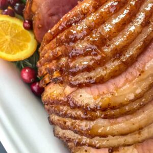 Orange Brown Sugar Glazed Ham - the perfect juicy main course for your holiday table! So easy to make, fully of flavor, and guaranteed to be a hit with your friends and family! #ham #orangeglazedham #christmas #dinner | https://withpeanutbutterontop.com