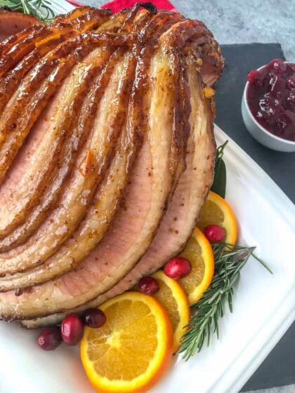 Orange Brown Sugar Glazed Ham - the perfect juicy main course for your holiday table! So easy to make, fully of flavor, and guaranteed to be a hit with your friends and family! #ham #orangeglazedham #christmas #dinner | https://withpeanutbutterontop.com