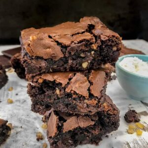 Triple Chocolate Walnut Fudge Brownies | soft, chewy, gooey centers with a crispy, crackle topping! The best brownies you will ever try! Filled with chocolate and finely chopped walnuts. Sure to become a repeat dessert in your home. #brownies #chocolate #triplechocolate | https://withpeanutbutterontop.com