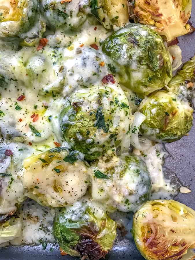 Cheesy Pepper Jack Roasted Brussels Sprouts with freshly grated pepper jack cheese make for the best side dish! They are very easy to make and come together on on sheet pan! Tender, crisp brussels sprouts are roasted with garlic, pepper jack cheese, and onions. #sheetpan #sheetpanrecipes #brusselssprouts #cheesybrusselssprouts | https://withpeanutbutterontop.com