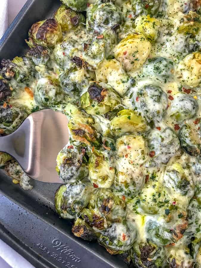 Cheesy Pepper Jack Roasted Brussels Sprouts with freshly grated pepper jack cheese make for the best side dish! They are very easy to make and come together on on sheet pan! Tender, crisp brussels sprouts are roasted with garlic, pepper jack cheese, and onions. #sheetpan #sheetpanrecipes #brusselssprouts #cheesybrusselssprouts | https://withpeanutbutterontop.com