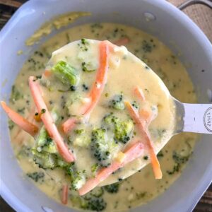 Make Panera's Broccoli Cheese Soup at home easily! This Broccoli Cheddar Soup comes together in one pan and is loaded with broccoli, carrots and cheddar cheese. Creamy, savory perfection! #soup #panerabroccolicheese #broccolicheddar | https://withpeanutbutterontop.com