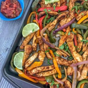 Easy Sheet Pan Chicken Fajitas - an easy, flavorful, one-pan meal that comes together effortlessly and with minimal cleanup. Great for lunches, meal prep, or if you're looking for a quick and simple dinner option tonight! #mealprep #sheetpanrecipes #sheetpan #chickenfajitas | https://withpeanutbutterontop.com