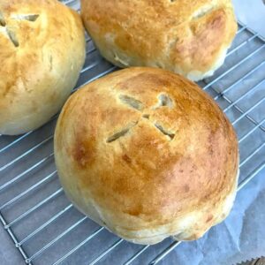 Learn how to make Bread Bowls at home with this simple recipe, containing only 6 ingredients! Golden and crispy on the outside while being soft and fluffy on the inside! Perfect for soups, stews, and dips! #homemadebread #breadbowls #soupbowls #soup | https://withpeanutbutterontop.com