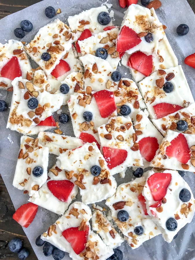Salted Almond Frozen Yogurt Bark with Berries is the best and easiest healthy snack to help you curb your cravings! Made with a handful of ingredients, simple to make, and guaranteed to be kid-friendly! #yogurtbark #froyo #frozenyogurt #healthysnacks | https://withpeanutbutterontop.com