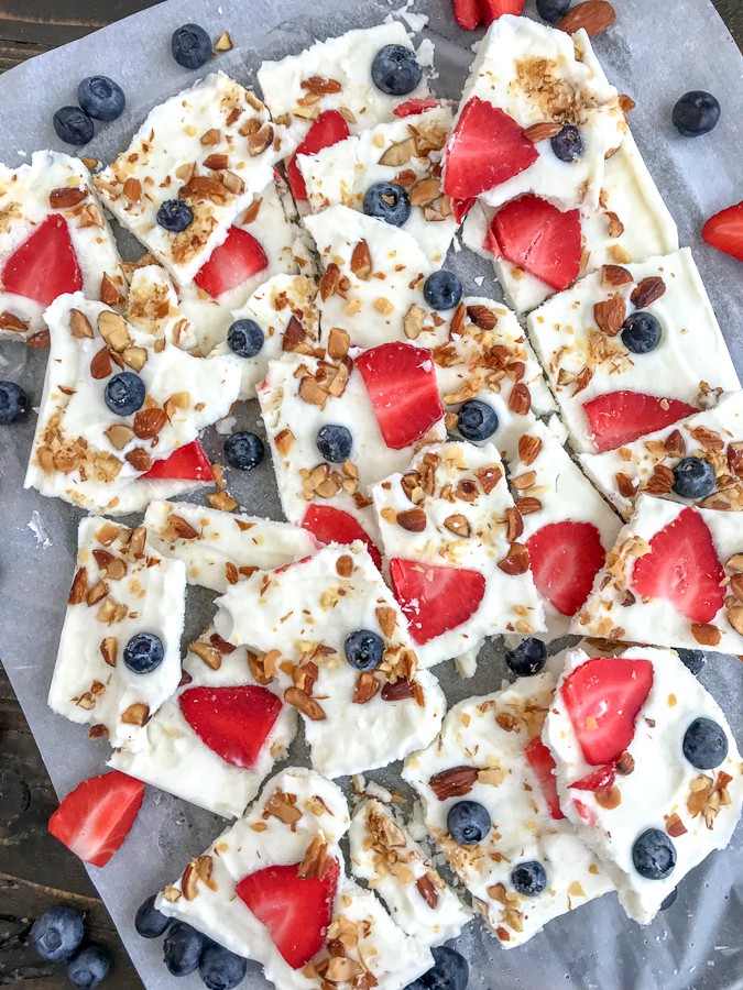 Salted Almond Frozen Yogurt Bark with Berries is the best and easiest healthy snack to help you curb your cravings! Made with a handful of ingredients, simple to make, and guaranteed to be kid-friendly! #yogurtbark #froyo #frozenyogurt #healthysnacks | https://withpeanutbutterontop.com