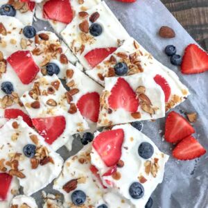 Salted Almond Frozen Yogurt Bark with Berries is the best and easiest healthy snack to help you curb your cravings! Made with a handful of ingredients, simple to make, and guaranteed to be kid-friendly! #yogurtbark #froyo #frozenyogurt #healthysnacks | https://withpeanutbutterontop.com