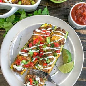 Taco Stuffed Zucchini Boats - a delicious, healthy and low-carb way to indulge in Taco Tuesday without the guilt. Filled with delicious taco flavors - I guarantee you won't miss the tortilla! #lowcarb #tacotuesday #zucchiniboats | https://withpeanutbutterontop.com