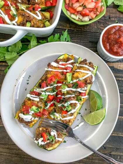 Taco Stuffed Zucchini Boats - a delicious, healthy and low-carb way to indulge in Taco Tuesday without the guilt. Filled with delicious taco flavors - I guarantee you won't miss the tortilla! #lowcarb #tacotuesday #zucchiniboats | https://withpeanutbutterontop.com