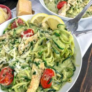 Creamy Chicken and Avocado Pesto Zoodles - a super creamy, easy, and healthy meal option that comes together in 30 minutes! Low-carb, low-calorie, high in healthy fats - this recipe is the ultimate comfort dish without the guilt. #lowcarb #zucchininoodles #zoodles #avocado | https://withpeanutbutterontop.com