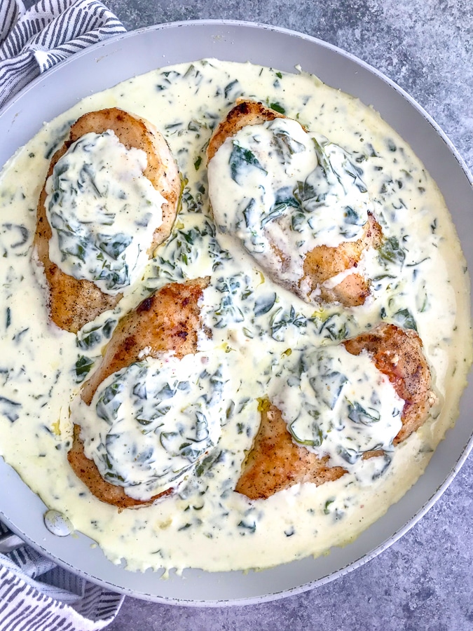 Creamy Chicken Florentine is the perfect date night recipe! The creamy spinach sauce is full of flavor, comes together in one pan, and is perfect served over pasta or rice! #chickenflorentine #creamyspinach #datenight #onepanrecipes | https://withpeanutbutterontop.com