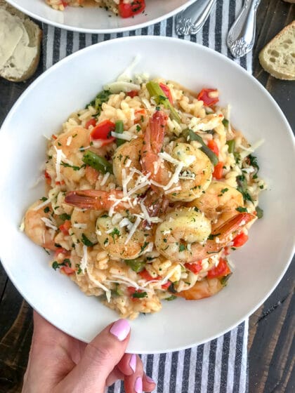 This Garlic Butter Shrimp with Asiago Risotto recipe is the perfect date night meal! Comes together in one pot, is bursting full of flavor and is so easy to make. I guarantee your taste buds will be floored! #risotto #garlicbuttershrimp #asiagorisotto | https://withpeanutbutterontop.com