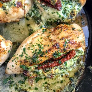Creamy and cheesy spinach and sun-dried tomato stuffed chicken breast that is undeniably delicious! You will be savoring each bite! A wonderful spin on stuffed chicken that will delight your family at the dinner table! #stuffedchicken #chicken #creamyspinach | https://withpeanutbutterontop.com