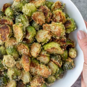 Bowl filled with Crispy Garlic Parmesan Brussels Sprouts.