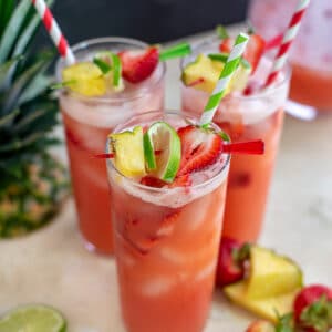 Glasses filled with Sparkling Strawberry Pineapple Limeade.