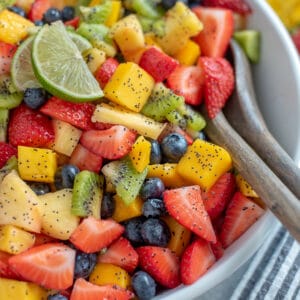 Bowl filled with fruit and tossed with a honey lime and poppyseed dressing.
