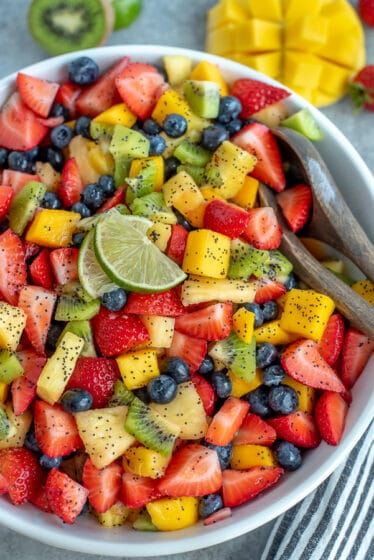 Bowl filled with fruit and tossed with a honey lime and poppyseed dressing.