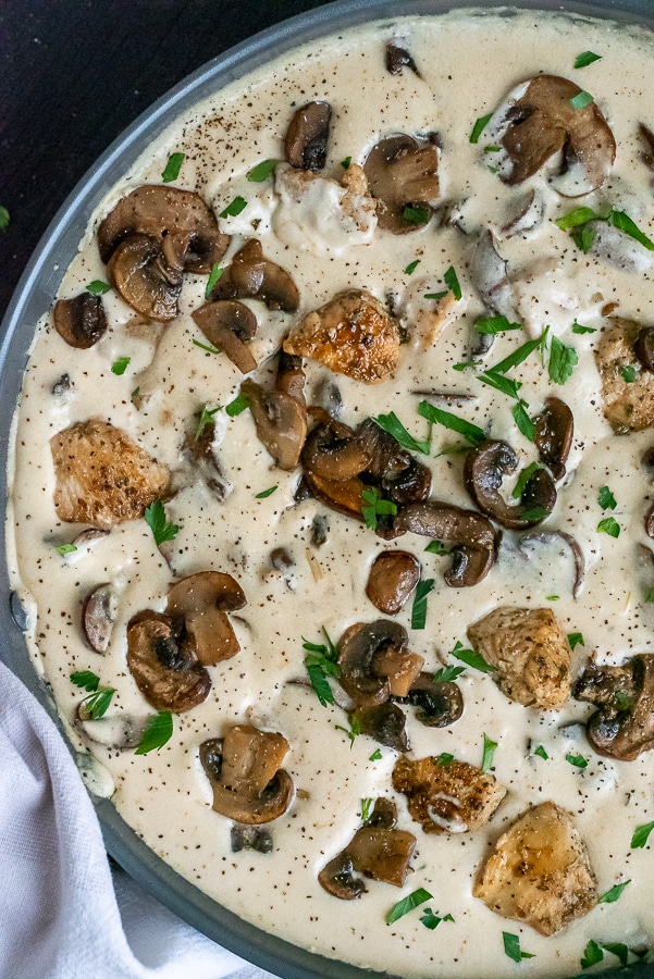 Pan of seared chicken in a creamy mushroom sauce.