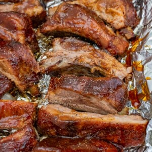 Sheet pan with bbq ribs and extra sauce.