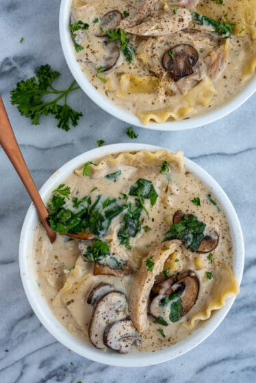 White bowl filled with creamy white chicken lasagna soup.