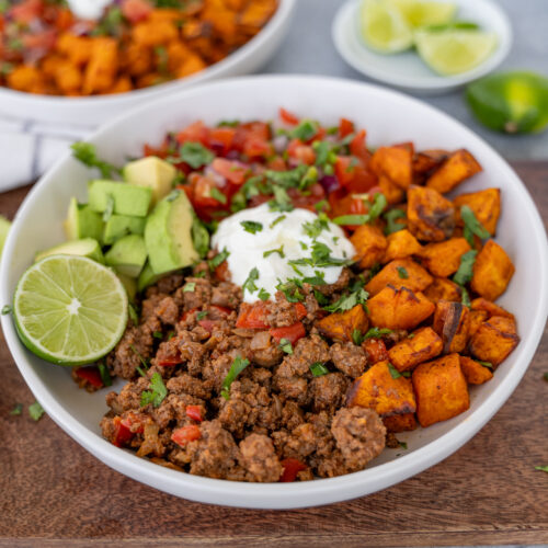 Sweet potato taco bowl with air fryer sweet potatoes, seasoned ground beef, avocado, pico de Gallo, and greek yogurt.